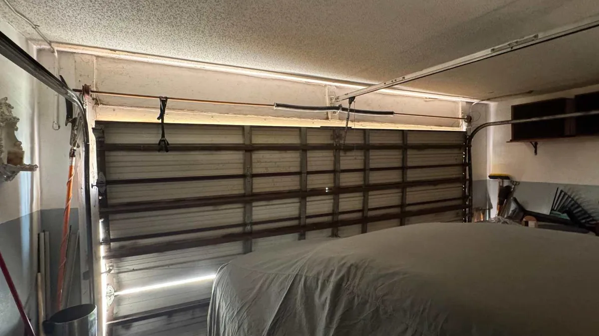 Garage interior showing the torsion shaft, drums and opener bracket